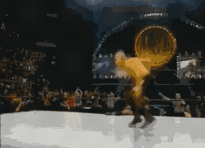 A Man In A White Shirt Is Standing In Front Of Another Man In A Boxing Ring GIF