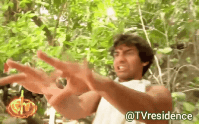 A Man In A White Shirt Is Standing In The Woods With His Arms Outstretched And The Words @Tvresidence Below Him GIF