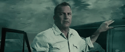 A Man In A White Shirt Is Standing Next To A Car In The Dark . GIF
