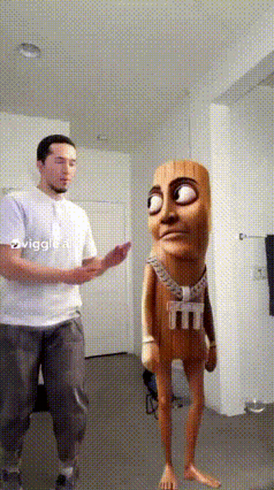 A Man In A White Shirt Is Standing Next To A Cartoon Character With A Shirt That Says M And M On It GIF