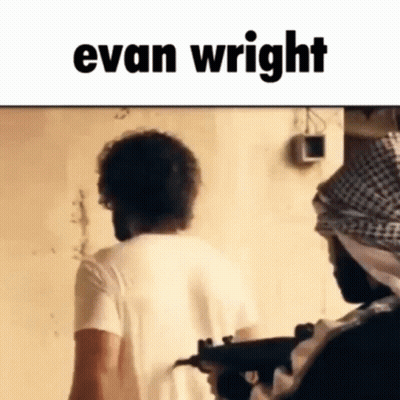 A Man In A White Shirt Is Standing Next To A Man With A Gun And The Name Evan Wright On The Bottom . GIF