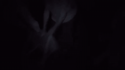A Man In A White Shirt Is Standing On A Suitcase In A Room GIF