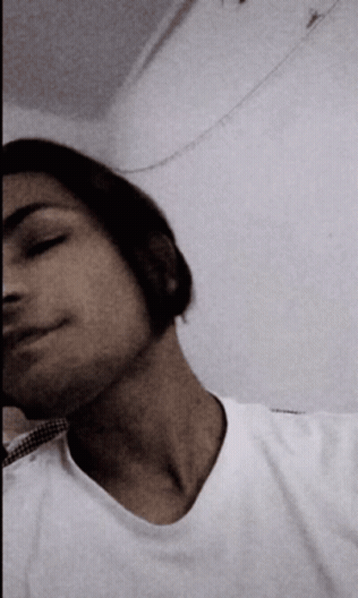 A Man In A White Shirt Is Taking A Picture Of Himself GIF