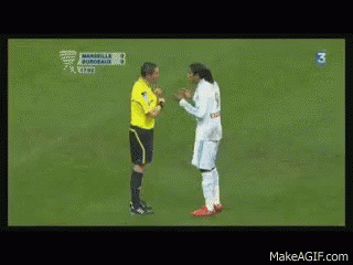A Man In A White Shirt Is Talking To Another Man In A Yellow Shirt With The Number 3 On The Bottom Right GIF
