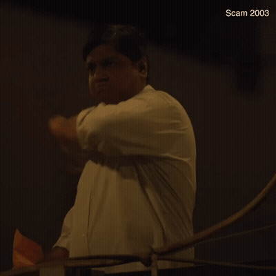 A Man In A White Shirt Is Throwing A Piece Of Paper In The Air And The Year 2003 Is Visible In The Corner GIF