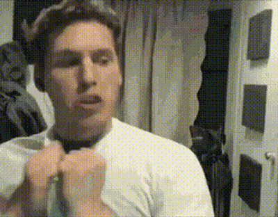 A Man In A White Shirt Is Tying A Tie GIF