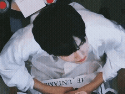 A Man In A White Shirt Is Writing On A Piece Of Paper That Says He Untaml GIF