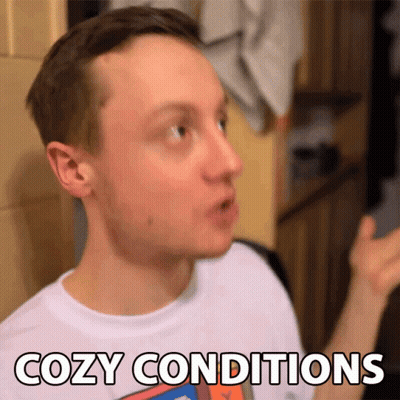 A Man In A White Shirt Says Cozy Conditions In Black Letters GIF