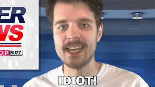 A Man In A White Shirt Says Idiot In Front Of A Sign That Says Buzz GIF