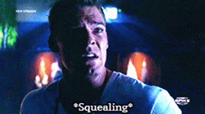 A Man In A White Shirt Says " Squealing " On The Screen GIF