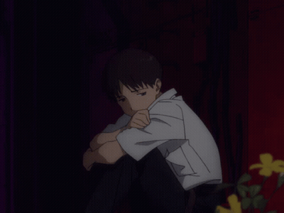 A Man In A White Shirt Sits With His Head Down GIF