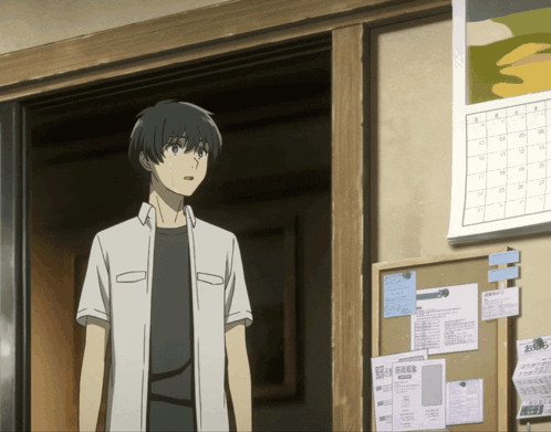 A Man In A White Shirt Stands In Front Of A Bulletin Board GIF