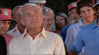 A Man In A White Shirt Stands In Front Of A Crowd Of People Wearing Hats With The Letter J On Them GIF
