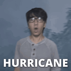 A Man In A White Shirt Stands In Front Of A Hurricane GIF