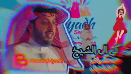 A Man In A White Shirt Stands In Front Of A Sign That Says Yash GIF