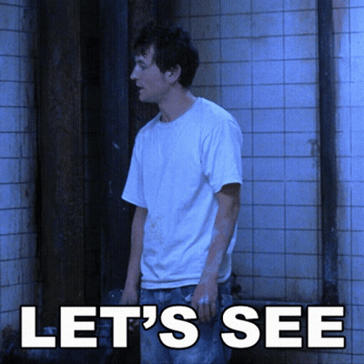 A Man In A White Shirt Stands In Front Of A Tiled Wall With The Words Let 'S See Above Him GIF