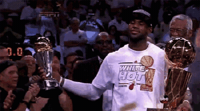 A Man In A White Shirt That Says White Hot Holds A Trophy GIF