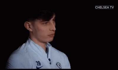 A Man In A White Shirt With A Chelsea Logo On It GIF