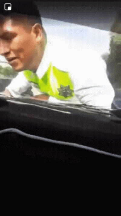A Man In A White Shirt With A Green Star On It GIF