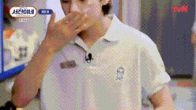 A Man In A White Shirt With A Microphone On His Neck Is Covering His Mouth . GIF
