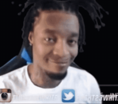 A Man In A White Shirt With A Twitter Icon On It GIF