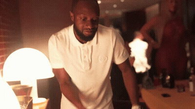 A Man In A White Shirt With The Letter O On It GIF
