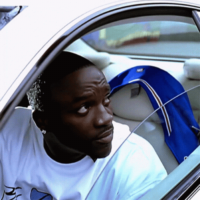 A Man In A White Shirt With The Letter R On It Is Sitting In A Car GIF