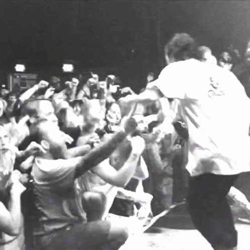 A Man In A White Shirt With The Letter R On The Back GIF