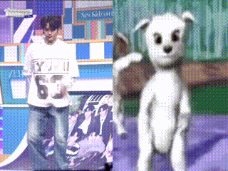 A Man In A White Shirt With The Number 6 On It Is Standing Next To A Stuffed Animal GIF
