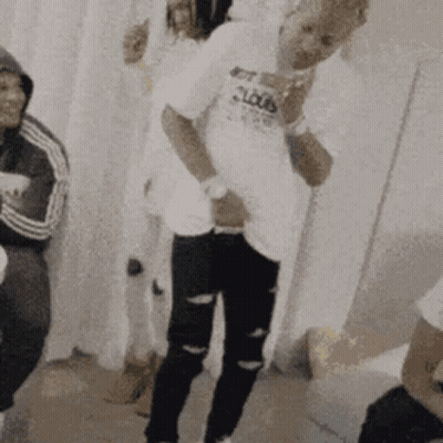 A Man In A White Shirt With The Word Clouds On It Is Standing In A Room With Other People . GIF