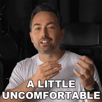 A Man In A White Shirt With The Words A Little Uncomfortable Above Him GIF