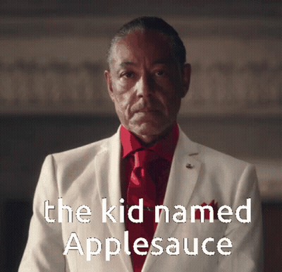A Man In A White Suit And Red Tie With The Words " The Kid Named Applesauce " Above Him GIF