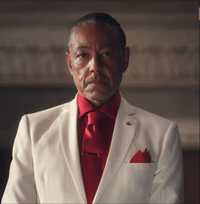 A Man In A White Suit Has A Red Tie GIF