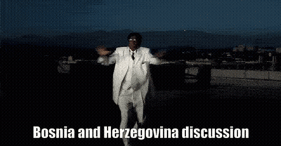 A Man In A White Suit Is Dancing With The Words Bosnia And Herzegovina Discussion Behind Him GIF