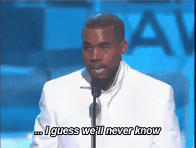 A Man In A White Suit Is Speaking Into A Microphone And Saying `` I Guess We 'Ll Never Know `` . GIF