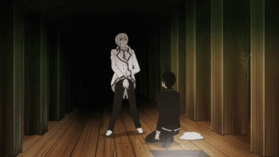 A Man In A White Suit Is Standing Next To A Man In A Black Suit On A Wooden Floor GIF