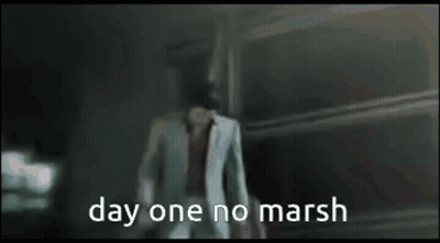 A Man In A White Suit Is Walking In A Dark Room With The Words Day One No Marsh On The Bottom GIF