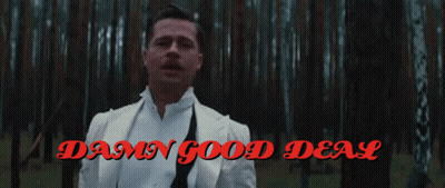 A Man In A White Suit Stands In A Forest With The Words Damn Good Deal GIF