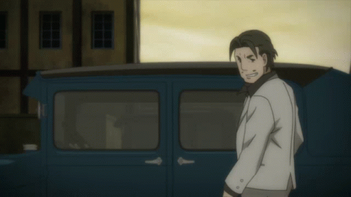 A Man In A White Suit Stands In Front Of A Blue Vehicle GIF