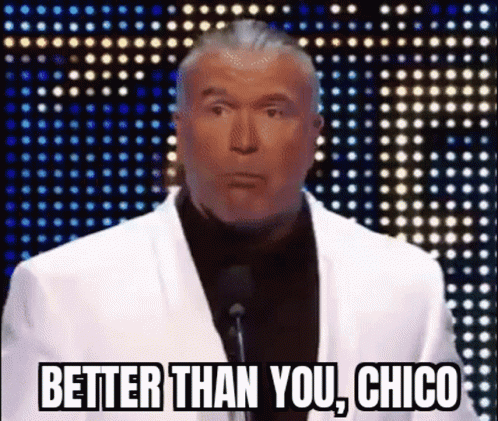 A Man In A White Suit Stands In Front Of A Microphone And Says " Better Than You Chico " GIF