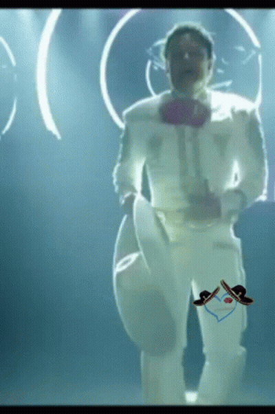A Man In A White Suit With A Sombrero On His Pants Is Dancing GIF