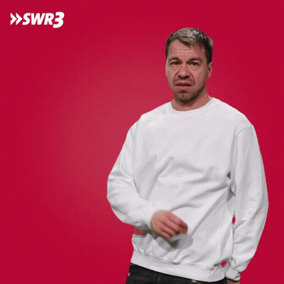 A Man In A White Sweatshirt Is Pointing At Something In Front Of A Red Background With The Letters Swr3 On It GIF
