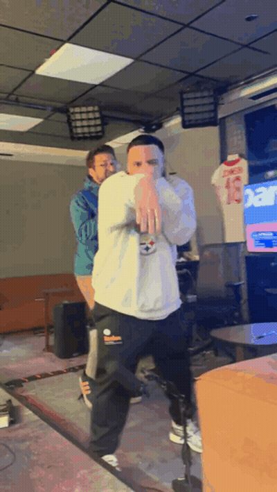 A Man In A White Sweatshirt With The Number 13 On It Is Dancing GIF