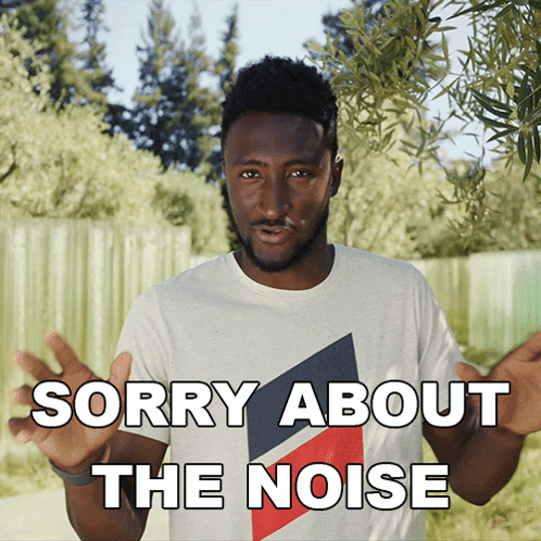 A Man In A White T-Shirt Says " Sorry About The Noise " GIF