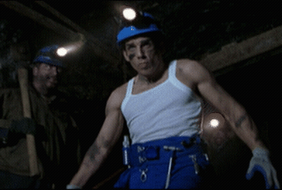 A Man In A White Tank Top And Blue Pants Has A Belt With Tools On It GIF
