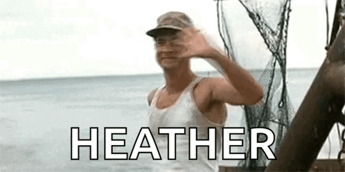 A Man In A White Tank Top And Hat Is Waving At The Camera While Standing On A Boat In The Ocean . GIF