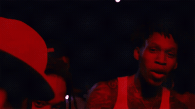 A Man In A White Tank Top Has A Tattoo Of A Horseshoe On His Arm GIF