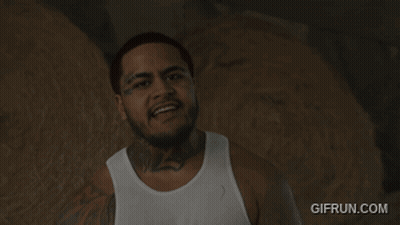 A Man In A White Tank Top Has A Tattoo On His Neck That Says ' Ls ' GIF