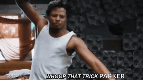 A Man In A White Tank Top Is Dancing In A Room With His Arms Outstretched . GIF
