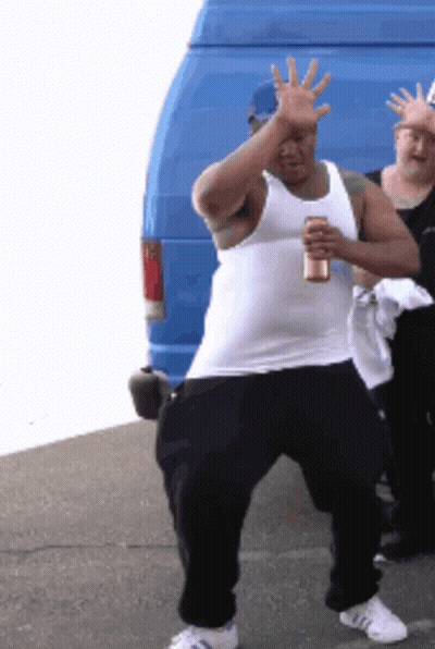 A Man In A White Tank Top Is Holding A Can Of Beer GIF